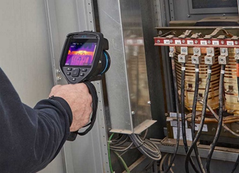 Electrician conducting commercial electrical inspection